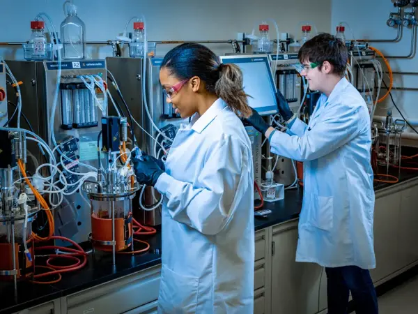 a couple of people in lab coats in a lab